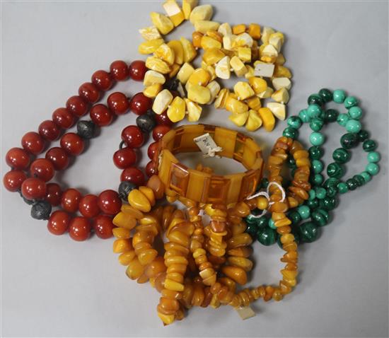 Two amber necklaces and a bracelet and two other necklaces.